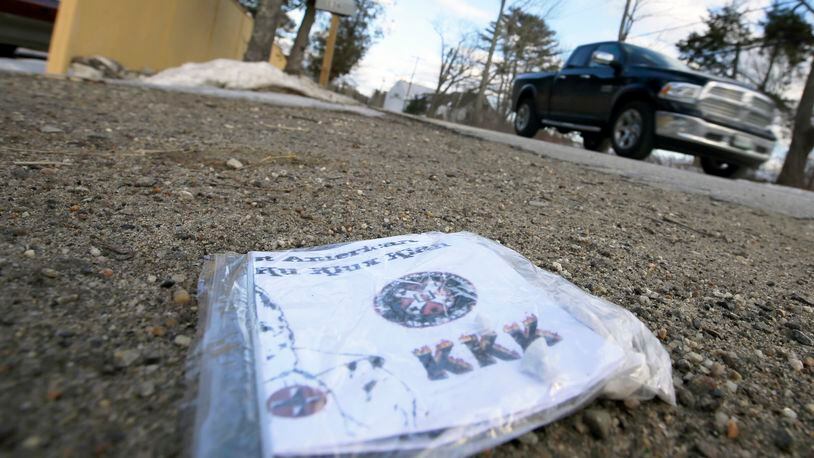 A Ku Klux Klan flier lying at the end of a driveway.