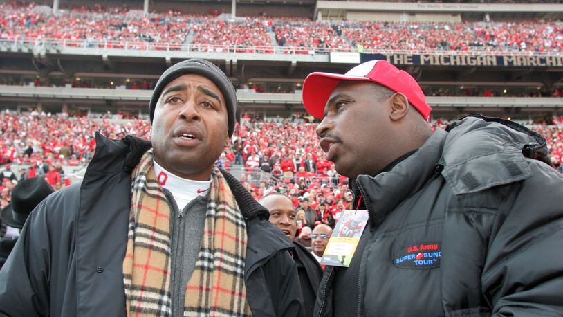 Former OSU football stars and Dayton natives Cris Carter (L) and Keith Byars chat on the sideline before the game.