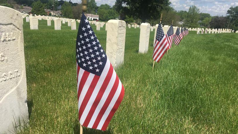 Some graves had flags placed next to them on Memorial Day, but others did not due to the coronavirus pandemic. STAFF/ PARKER PERRY