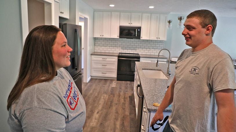 Tommy Rowe, senior CTC students who worked on the CTC 2019 project house, talks with Lynn Cochran, the owner of the new house, during the open house Tuesday. Students showed up at the beginning of the school year to find only a basement and as the year draws to an end, the house is complete. BILL LACKEY/STAFF