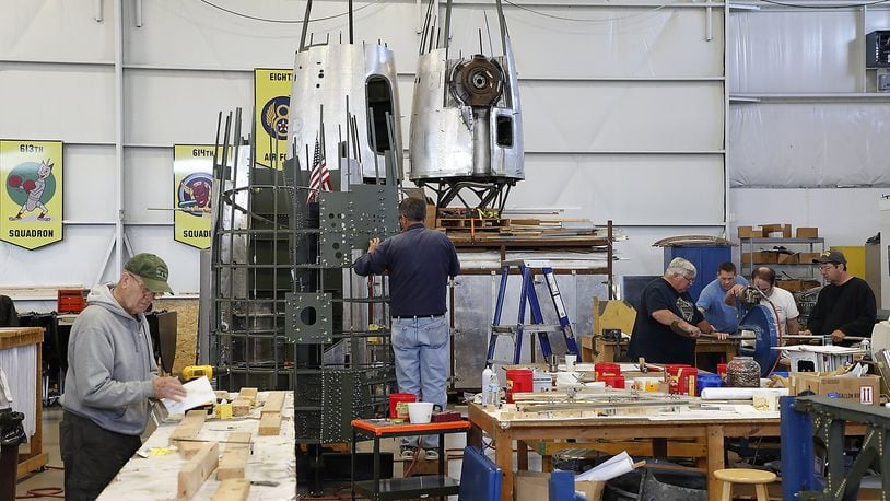 Volunteers at the Champaign Aviation Museum work on different parts of the B-17 Bomber restoration project in the museum Thursday. Bill Lackey/Staff
