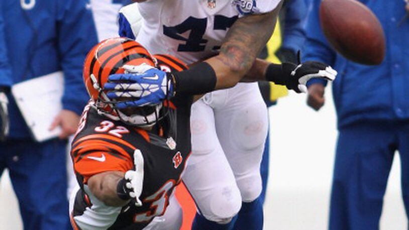 CINCINNATI, OH - DECEMBER 08: Chris Crocker #32 of the Cincinnati Bengals battles for the ball with Weslye Saunders #47 of the Indianapolis Colts during their game at Paul Brown Stadium on December 8, 2013 in Cincinnati, Ohio. The Bengals defeated the Colts 42-28. (Photo by John Grieshop/Getty Images)