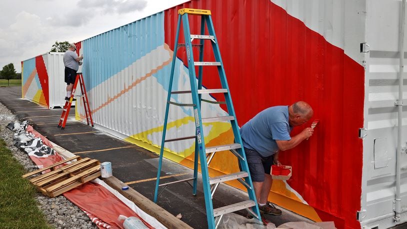 Volunteers Mike Ambuske (left) and Tom McGeean paint shipping containers in the parking lot of the First Christian Church. First Christian Church is partnering with Lifeline Christian Mission for the annual "Birthday Gift to Jesus" outreach program to send food and supplies to Honduras. The 40-foot containers are being outfitted and transformed into vocational training centers to teach welding, carpentry and electrical work. After they're completed, the containers will be sent to Honduras. First Christian Church will hold a dedication celebration Sunday from 10 a.m. to 3 p.m. to celebrate the completion of the containers. BILL LACKEY / STAFF