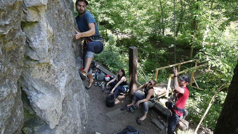 Jackson Pope works his way up a limestone cliff as he and his friends, from left, Emily Andrews, Mallory Hutton and Michael Barr rock climb at Mad River Gorge Tuesday. BILL LACKEY/STAFF