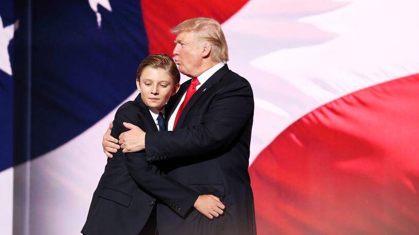 CLEVELAND, OH - JULY 21: Donald Trump embraces his son Barron Trump after he delivered his speech on the fourth day of the Republican National Convention on July 21, 2016 at the Quicken Loans Arena in Cleveland, Ohio. (Photo by John Moore/Getty Images)