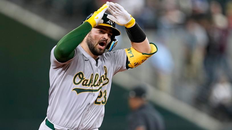 Oakland Athletics' Shea Langeliers celebrates his two-run home run against the Texas Rangers during the ninth inning of a baseball game in Arlington, Texas, Tuesday, April 9, 2024. (AP Photo/Tony Gutierrez)