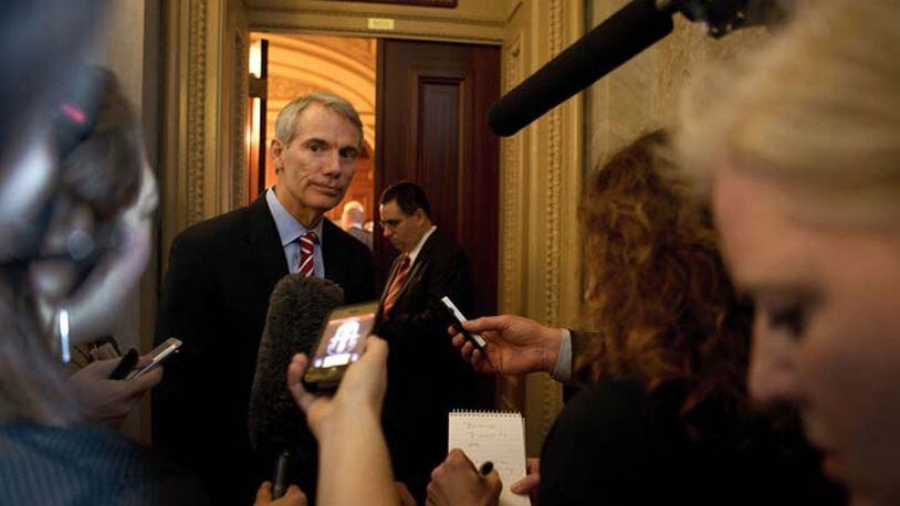 Sen. Rob Portman (R-Ohio) speaks to reporters as he departs a Senate Republican policy luncheon on Capitol Hill in Washington, April 9, 2013. Family members of Newtown shooting victims visited members of Congress Tuesday to press for gun legislation. (Doug Mills/The new York Times)