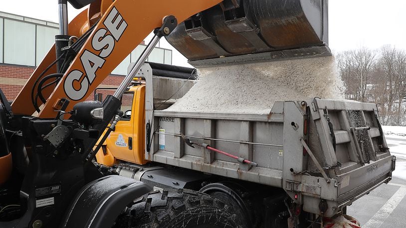 A City of Springfield salt truck is filled with salt Monday. BILL LACKEY/STAFF