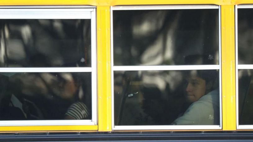A 3-year-old boy was left strapped on a school bus for more than an hour, his mother said.
