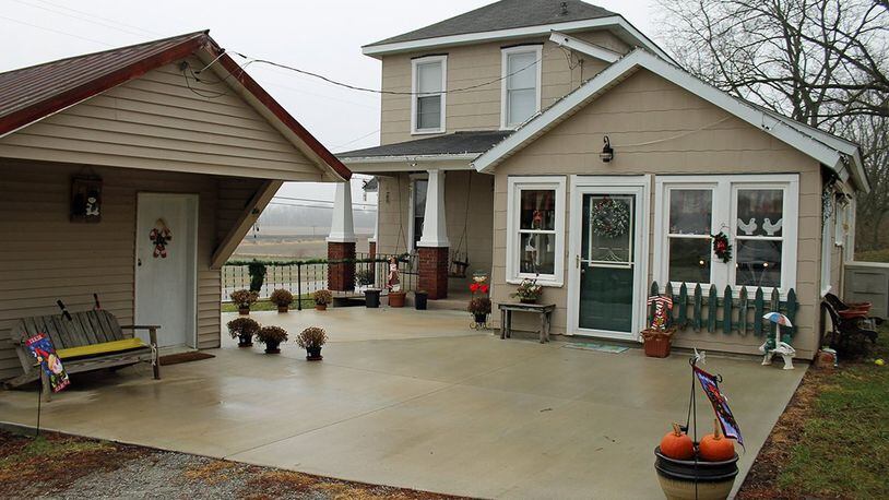 A covered porch and a patio provide plenty of space for outdoor living and entertaining.