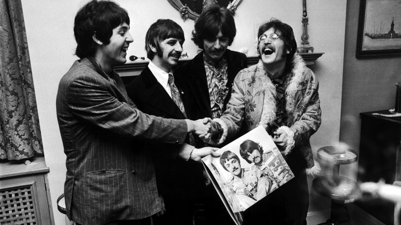 The Beatles (left  to right) George Harrison, Ringo Starr, John Lennon and Paul McCartney, hold the sleeve of  "Sgt. Pepper's Lonely Hearts Club Band," at the press launch for the album, held at Brian Epstein's house on May 19, 1967.
