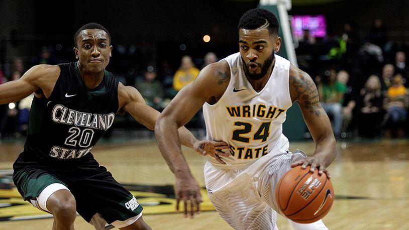 Wright State’s Mark Alstork tries to maneuver past Cleveland State’s Bobby Word during their game at the Nutter Center last season. TIM ZECHAR / CONTRIBUTED