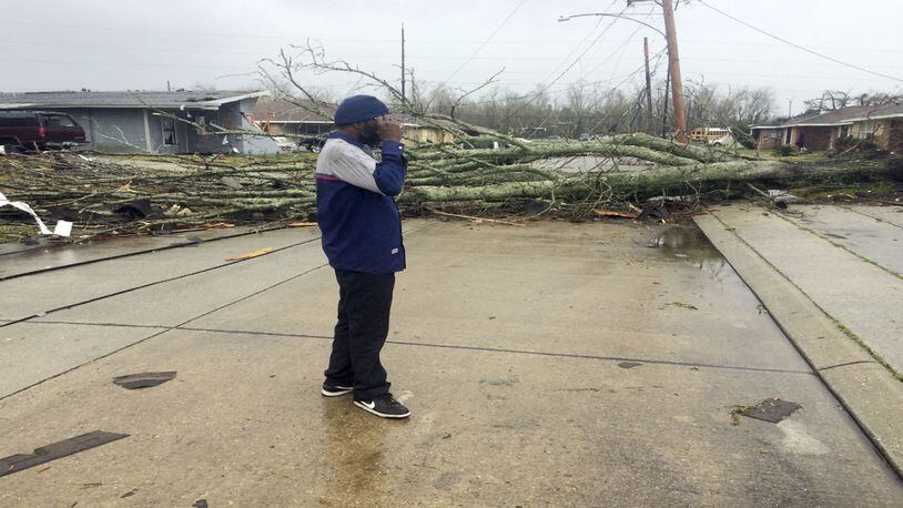 Silas Battie walks around the east New Orleans neighborhood after a tornado touchdown, Tuesday, Feb. 7, 2017. At least three tornados touchdown causing damage top buildings.