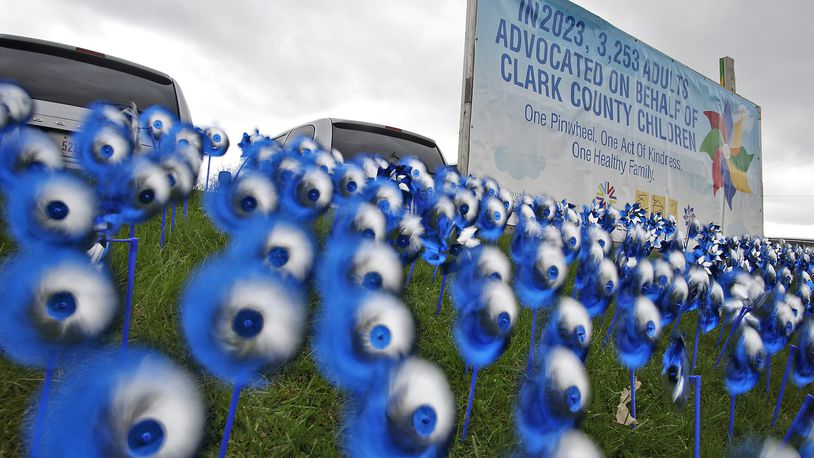 A sea of blue and silver pinwheels whirl in the breeze Wednesday, April 3, 2024 in front of Clark County Job and Family Services for Child Abuse Prevention Month. BILL LACKEY/STAFF
