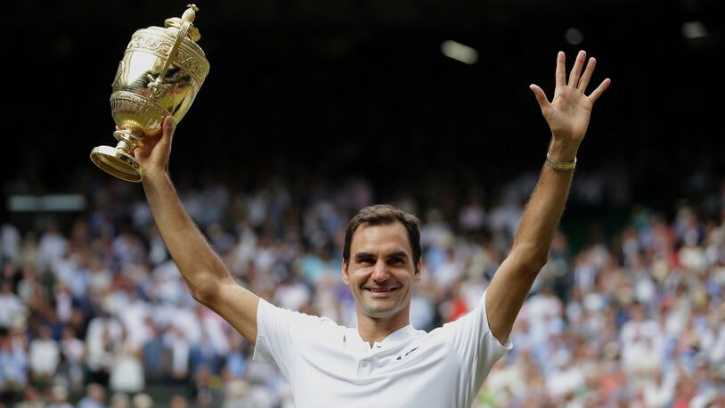 Switzerland's Roger Federer celebrates with the trophy after beating Croatia's Marin Cilic in the Men's Singles final match on day thirteen at the Wimbledon Tennis Championships in London Sunday, July 16, 2017. (Daniel Leal-Olivas/Pool Photo via AP)