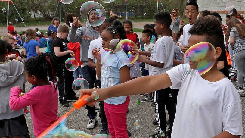 Students at Perrin Woods Elementary School celebrated Autism Awareness Month with a bubble blowing event on the school’s playground Wednesday. This was the fourth year the school has celebrated Autism Awareness Month with bubbles. BILL LACKEY/STAFF