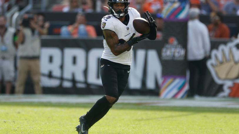 Baltimore Ravens safety Geno Stone (26) intercepts a pass during the second half of an NFL football game against the Cleveland Browns, Sunday, Oct. 1, 2023, in Cleveland. (AP Photo/Ron Schwane)