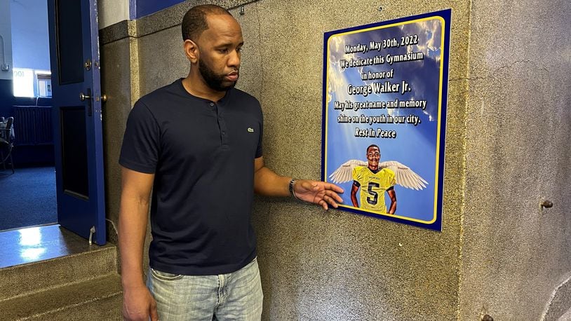 James Cooper stands next to a tribute to his late brother George Walker Jr., whose memory inspires Cooper's mission to provide a safe space for area youth. Hasan Karim/Staff