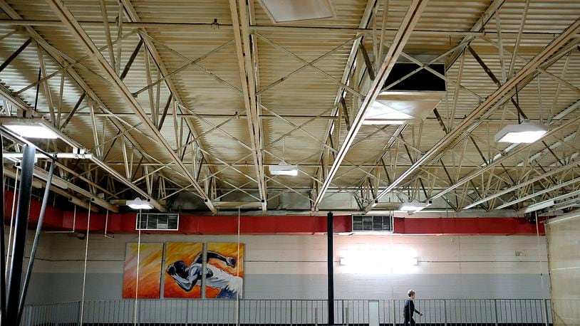 A guest walks on the second floor walking track around the Springfield YMCA gymnasium. BILL LACKEY/STAFF