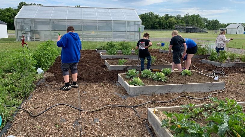 Graham Middle/High School FLIGHT program students working in the garden. CONTRIBUTED