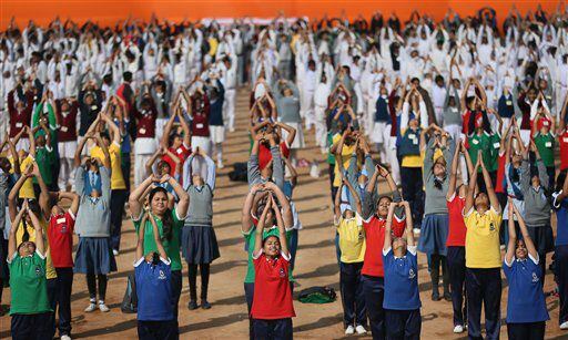 Indian school children perform Surya Namaskar or Sun salutation during a function to mark 150th birth anniversary of Swami Vivekananda.
