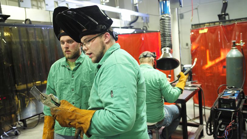Eric Schellentrager and Cody Herron look over their welds in the Welding Lab. Bill Lackey/Staff