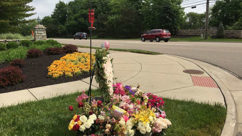 A floral memorial has taken shape across from where a traffic accident a week ago resulted in the death of a Butler County woman assisting crash victims. Staff photo by Lawrence Budd