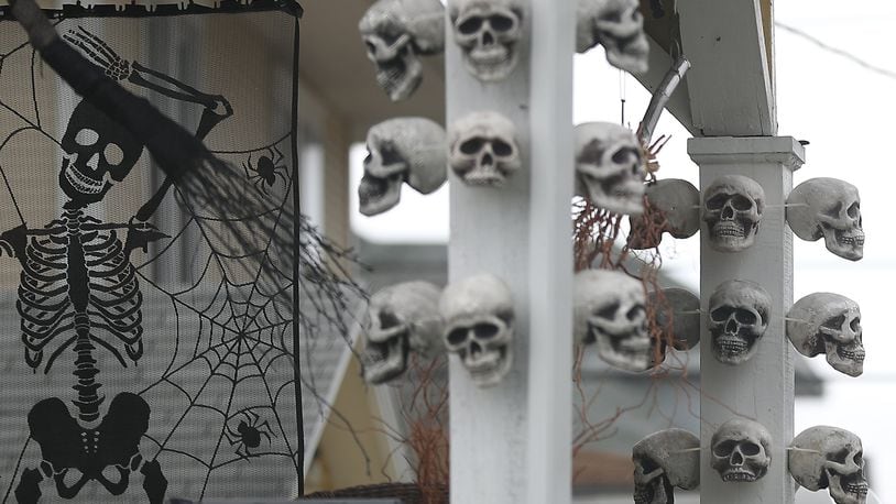 Skulls and skeletons decorate the front of a house along North Murray Street in Springfield for Halloween.