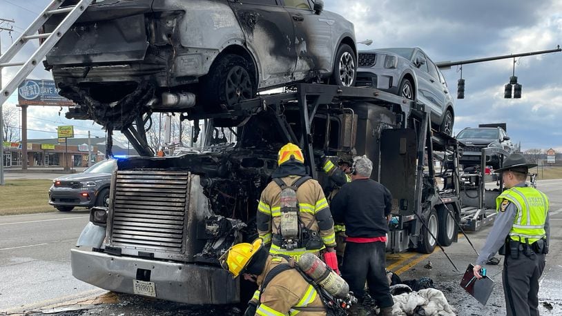 A tractor-trailer rig carrying Kia vehicles caught fire Thursday afternoon on Troy Road near Hillcrest Avenue. BILL LACKEY/STAFF