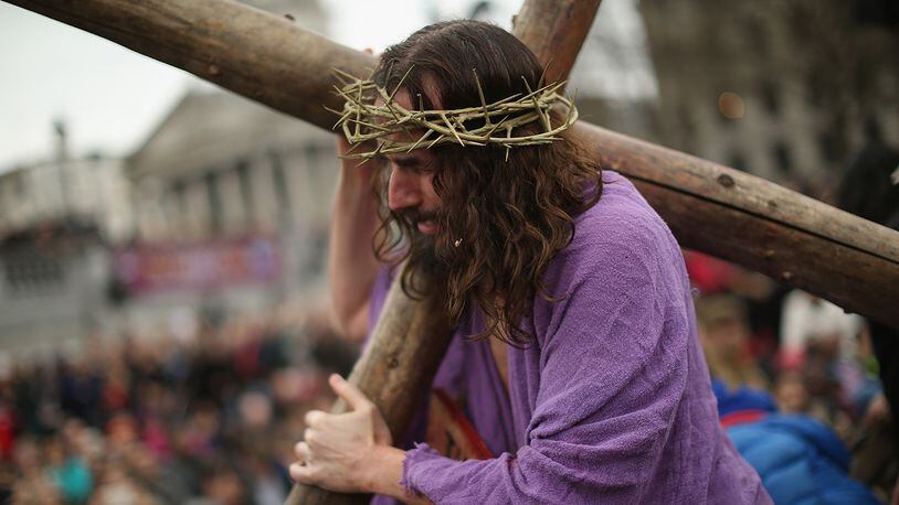 Actor James Burke-Dunsmore playing Jesus drags the cross during the Wintershall's 'The Passion of Jesus' production on Good Friday in Trafalgar Square on April 3, 2015 in London, England. Good Friday is a Christian religious holiday before Easter Sunday, which commemorates the crucifixion of Jesus Christ on the cross. The Wintershall's theatrical production of 'The Passion of Jesus' includes a cast of 100 actors, horses, a donkey and authentic costumes of Roman soldiers in the 12th Legion of the Roman Army.  (Photo by Dan Kitwood/Getty Images)