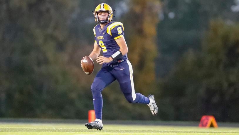 Springfield High School senior quarterback Bryce Schondelmyer rolls out to pass during their game against Miamisburg on Friday night in Springfield. CONTRIBUTED PHOTO BY MICHAEL COOPER