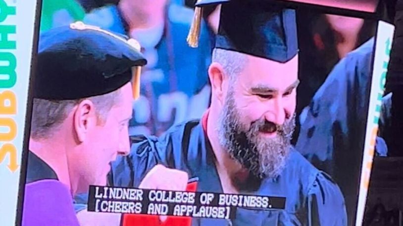 Jason Kelce, wearing shorts and a sleeveless vest under his cap and gown, didn't say anything while receiving his University of Cincinnati diploma — only smiling big and posing for pictures alongside school officials. WCPO/CONTRIBUTED