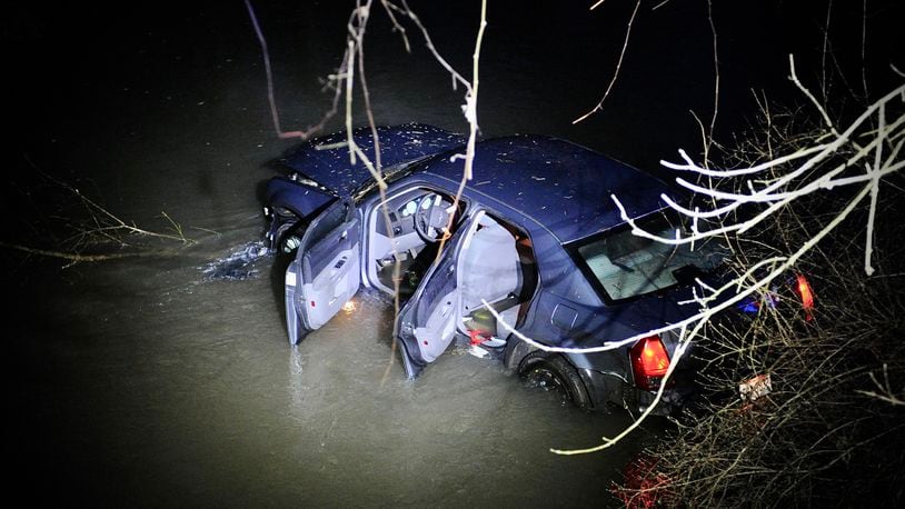 A pursuit that started in Donnelsville in Clark County ended after the car went off Scarff Road near New Carlisle and into a creek in Miami County. One suspect was taken into custody and the second ran from the scene. MARSHALL GORBY/STAFF