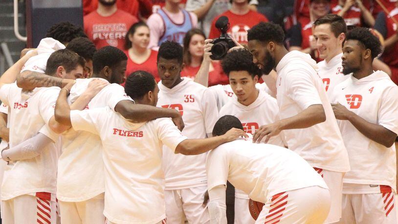 Dayton huddles before a game against Rhode Island on March 1, 2019, at UD Arena.