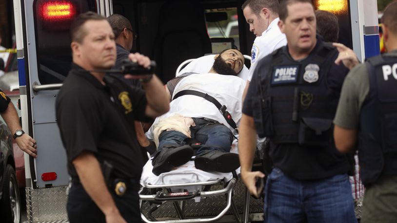 Ahmad Khan Rahami is taken into custody after a shootout with police Monday, Sept. 19, 2016, in Linden, N.J. Rahami was wanted for questioning in the bombings that rocked the Chelsea neighborhood of New York and the New Jersey shore town of Seaside Park. (Nicolaus Czarnecki/Boston Herald via AP)