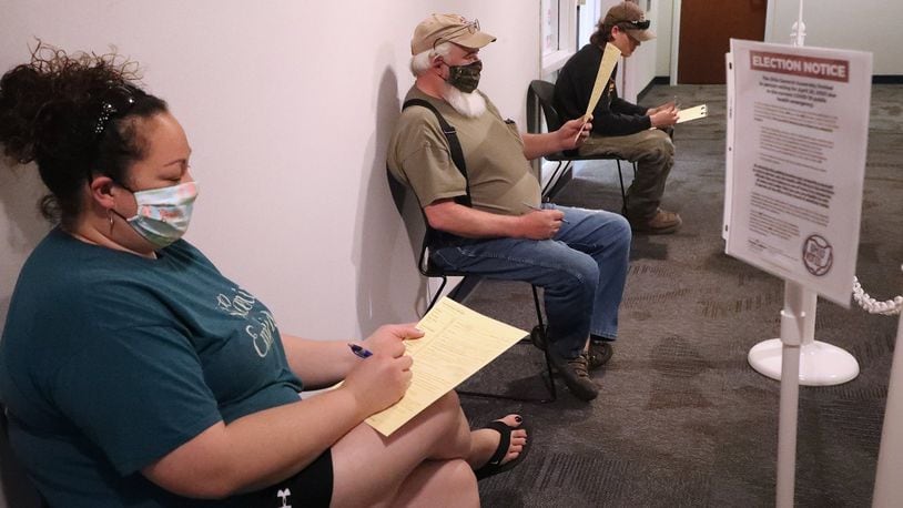 Voters wait outside the Champaign County Board of Elections during the April election. BILL LACKEY/STAFF
