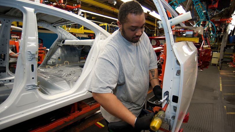 Kytwon Norman of Youngstown, Ohio, assembles the door of a Chevy Cruze at the Lordstown GM plant in this file photo. The plant is slated for probable closure, affecting 1,600 workers. (Jason Miller/MCT)