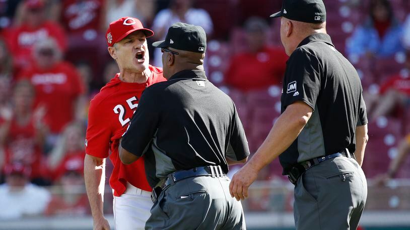 CINCINNATI, OH - MAY 29: Cincinnati Reds manager David Bell #25 is restrained by first base umpire Laz Diaz after being ejected from the game by crew chief Jeff Nelson in the eighth inning of a game against the Pittsburgh Pirates at Great American Ball Park on May 29, 2019 in Cincinnati, Ohio. The Pirates won 7-2. (Photo by Joe Robbins/Getty Images)