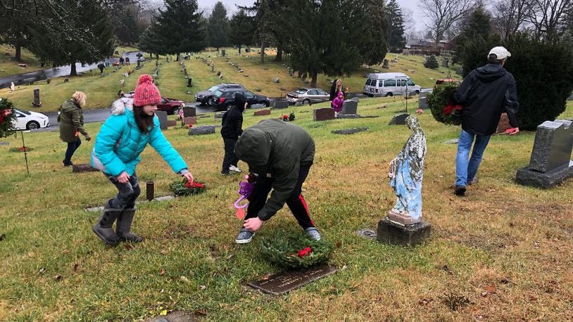 More than 100 people gathered at St. Bernard Cemetery to support the first event there for National Wreaths Across America Day. Another event was held across town at Springfield Burying Grounds. Photo by Brett Turner