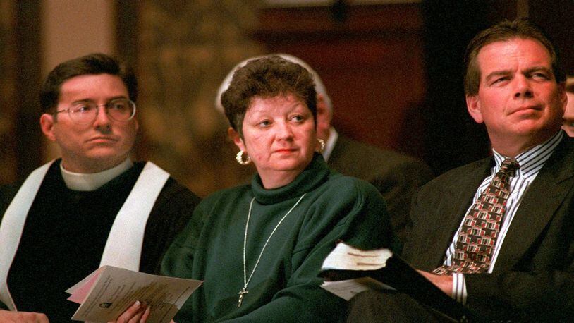 Norma McCorvey, the "Jane Roe" in the 1973 Roe v. Wade decision, is flanked by The Reverend Robert L. Schenck of the National Clergy Council, left, and The Rev. Phillip Benham of Operation Rescue National during a memorial service at Georgetown University in Washington, D.C. Sunday, Jan. 21, 1996. (AP Photo/Cameron Craig)