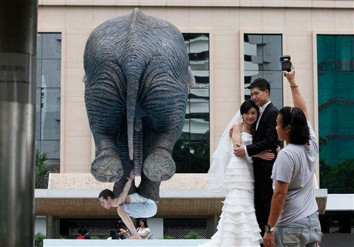 Statue of man balancing elephant