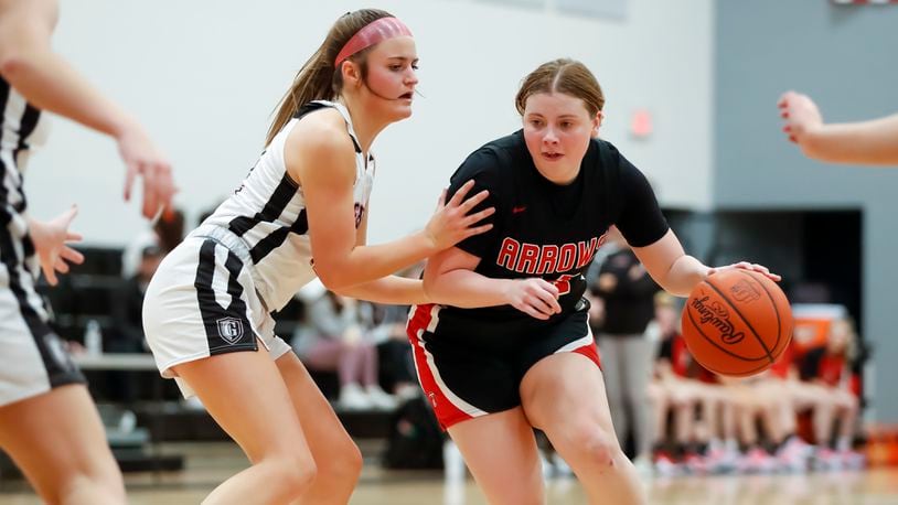 Tecumseh High School senior Madilynn Moore is guarded by Greenon sophomore Avery Minteer during their game on Wednesday night at Greenon High School. The Arrows won 56-53. CONTRIBUTED PHOTO BY MICHAEL COOPER