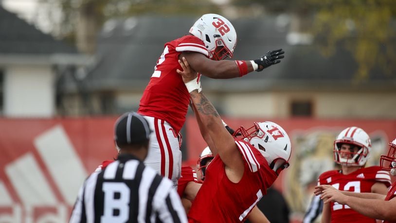 Wittenberg's Angel Bravo lifts Bryce Anderson after a touchdown run against DePauw on Saturday, Oct. 21, 2023, at Edwards-Maurer Field in Springfield. David Jablonski/Staff