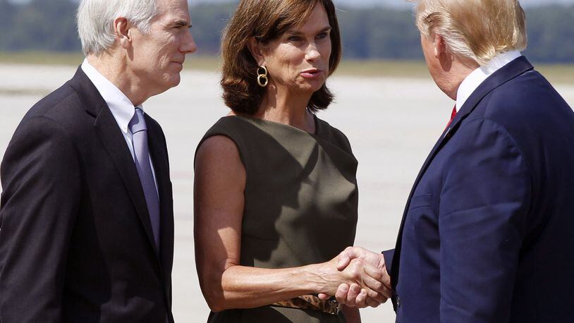 U.S. Senator Rob Portman and his wife Jane are greeted by President Trump at Wright-Patterson Air Force Base, Wednesday, Aug. 7, 2019, in Dayton, Ohio. TY GREENLEES/STAFF