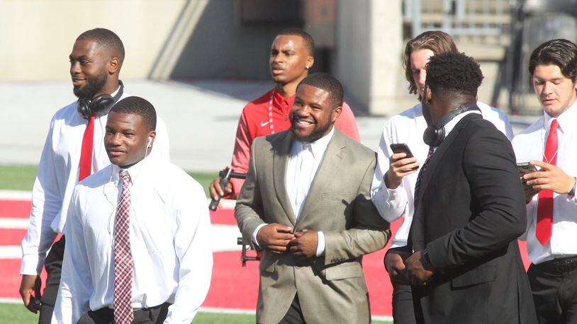 Ohio State’s Mike Weber, center, smiles as the team arrives at Ohio Stadium before a game against UNLV on Saturday, Sept. 23, 2017, in Columbus. David Jablonski/Staff