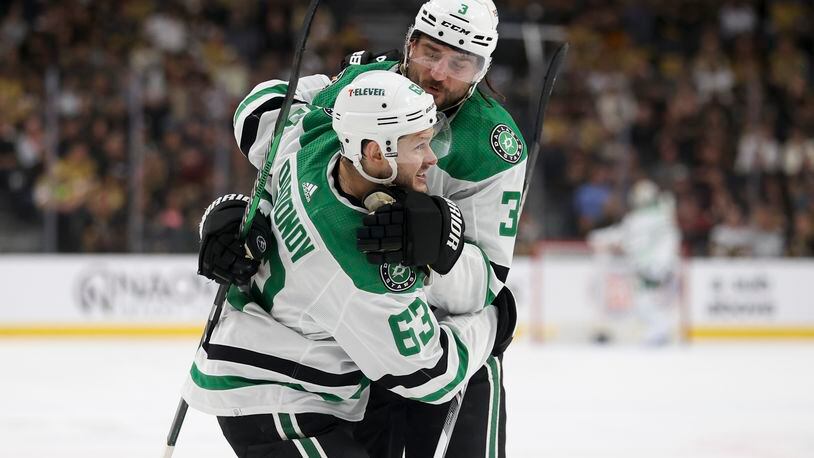 Dallas Stars right wing Evgenii Dadonov (63) and defenseman Chris Tanev (3) celebrate after Dadonov's goal during the first period against the Vegas Golden Knights in Game 4 of an NHL hockey Stanley Cup first-round playoff series Monday, April 29, 2024, in Las Vegas. (AP Photo/Ian Maule)