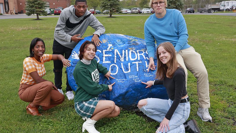 Springfield High School seniors with the Spirit Rock in front of the school Thursday, May 4, 2023. The seniors are, clockwise from left, Nadjah Franklin-Grant, Jimmy Gamblin, Owen Dooley, Karlie Bowen and Jasmonica Gallegos. Fifteen years ago, the first students began classes in the new, combined Springfield High School.  BILL LACKEY/STAFF
