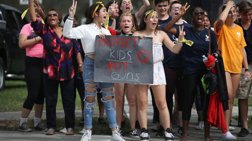 Hundreds of West Boca High School students arrive at Marjory Stoneman Douglas High School Tuesday, Feb. 20, 2018, after they walked there in honor of the 17 students and teachers who were killed in last week’s shooting massacre in Parkland, Florida.