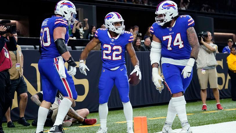 Buffalo Bills running back Matt Breida (22) celebrates his touchdown with guard Cody Ford (74) and center Mitch Morse (60) in the second half of an NFL football game against the New Orleans Saints in New Orleans, Thursday, Nov. 25, 2021. (AP Photo/Derick Hingle)