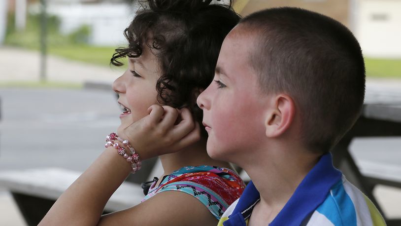Elizabeth, 7, sits with her twin brother, Logan, in May at Moorefield Family Park. Elizabeth is transgender and started out life as Landon, a boy. Her mother worries about the impact changing policies on transgender bathroom use at school will have on Elizabeth. Bill Lackey/Staff